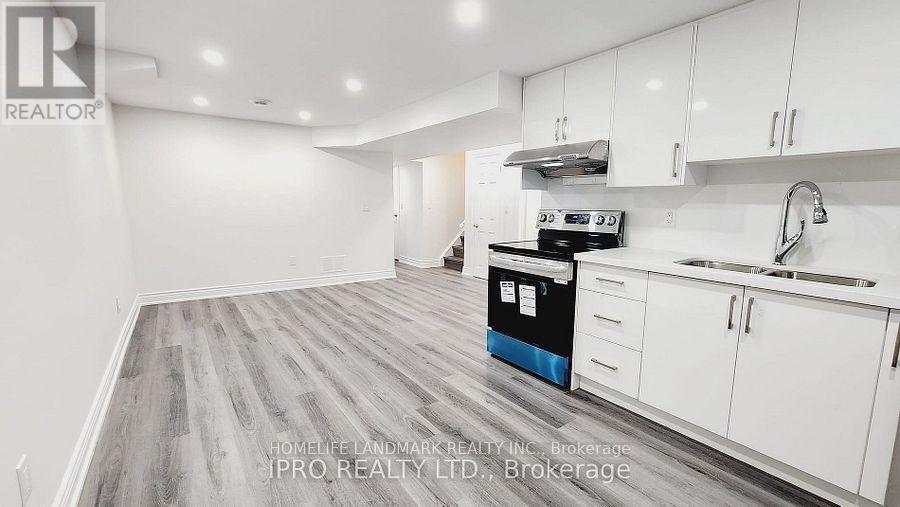 A kitchen with white cabinets and a blue dishwasher.