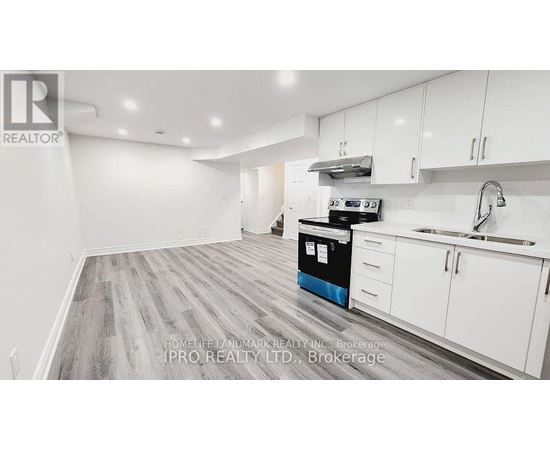 A kitchen with white cabinets and a blue dishwasher.