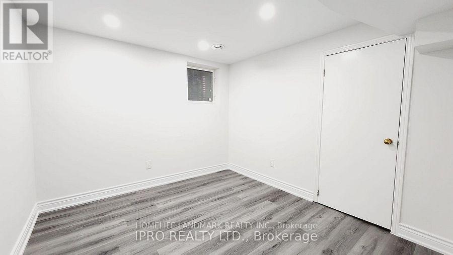 A white room with a door and a window.