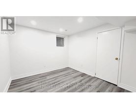 A white room with a door and a window.