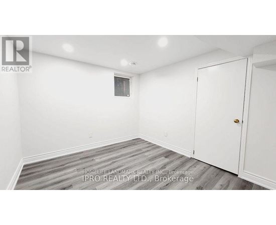 A white room with a door and a window.