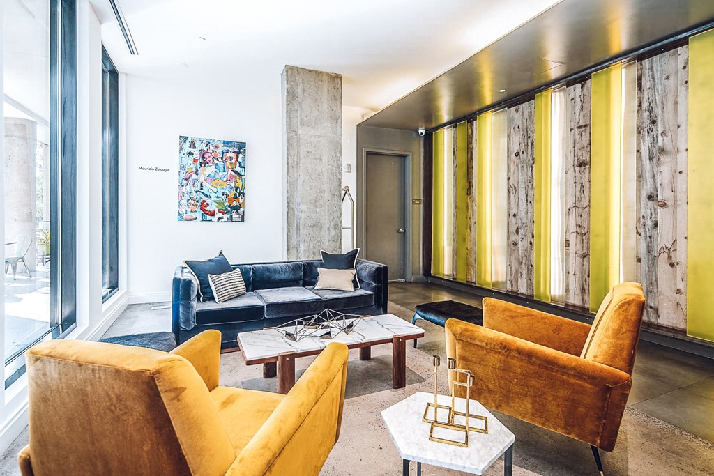 a living room with couches and chairs and a large window