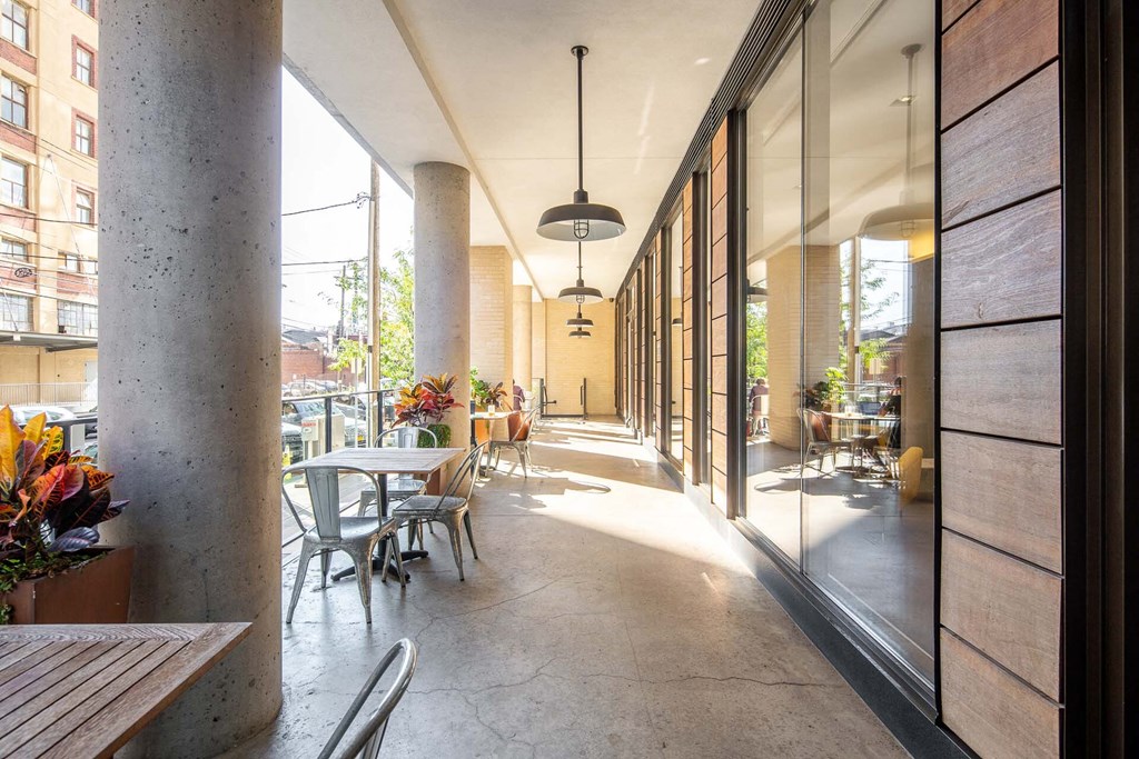 a long corridor with tables and chairs in a restaurant
