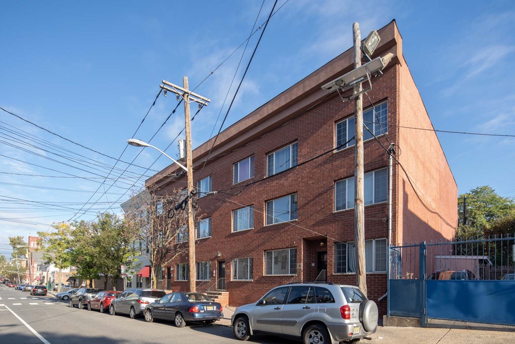 a large brick building with cars parked in front of it