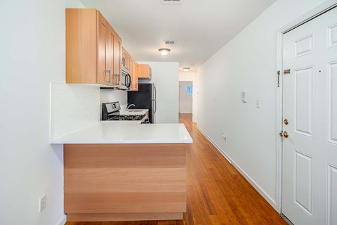 a kitchen with wooden cabinets and a white counter top