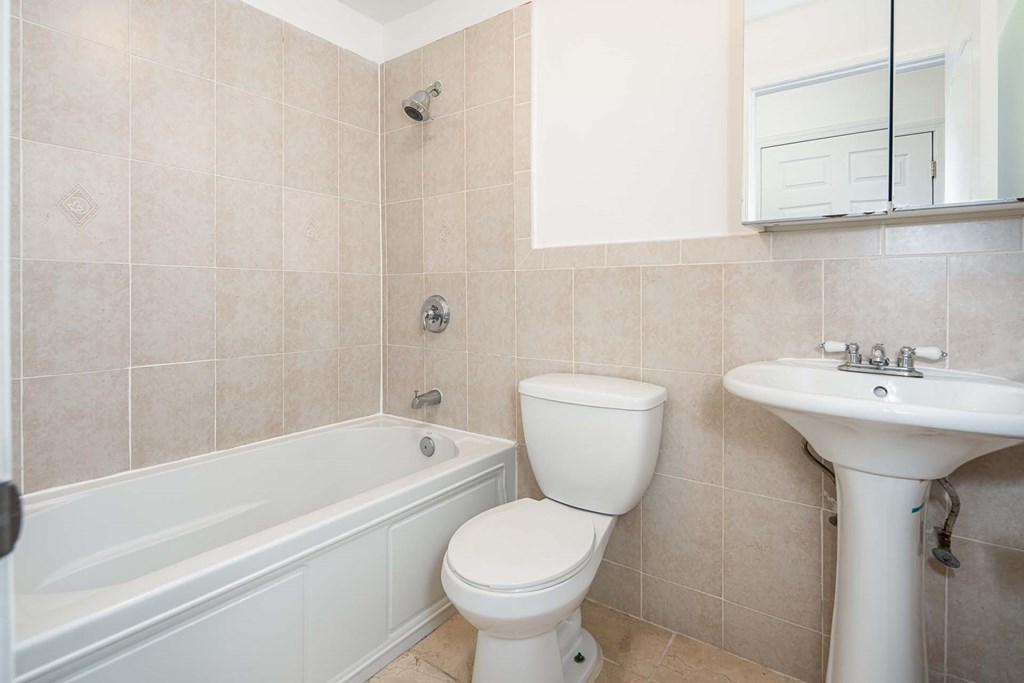 a bathroom with a sink toilet and a bath tub