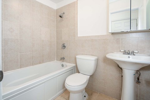 a bathroom with a sink toilet and a bath tub