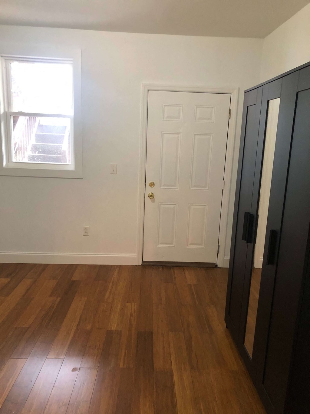 an empty room with a door and a window