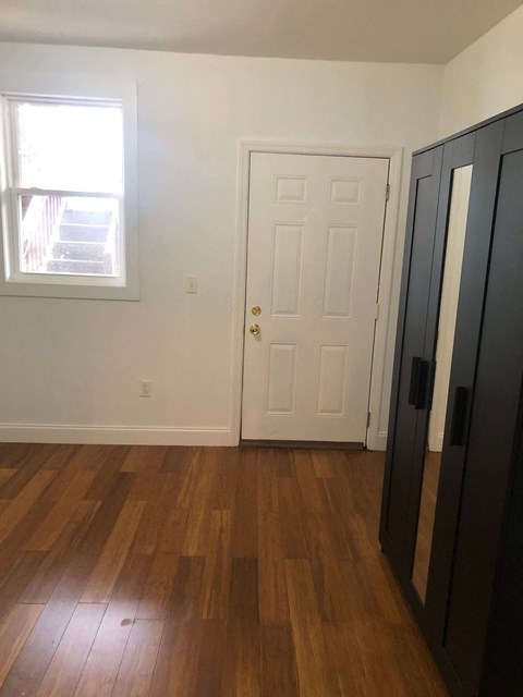 an empty room with a door and a window