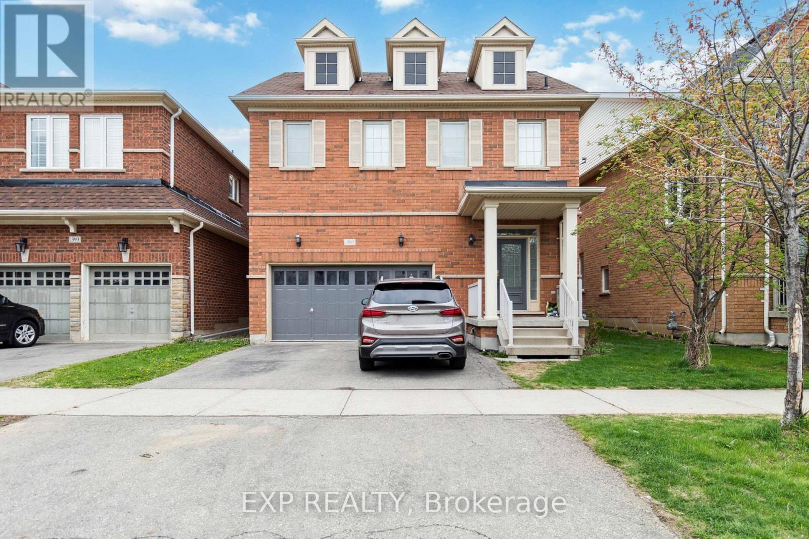 A house with a car parked in front of it.