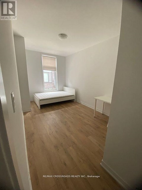 A bedroom with a bed and a window.