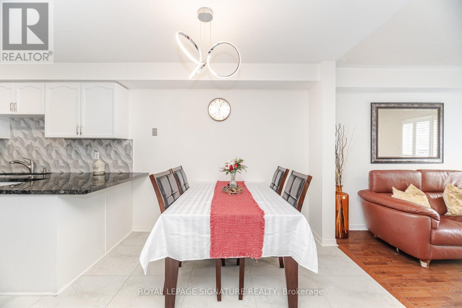 A dining room with a table set for four.