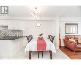 A dining room with a table set for four.