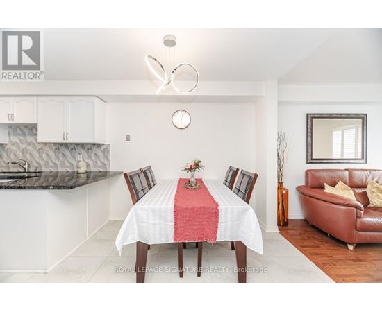 A dining room with a table set for four.
