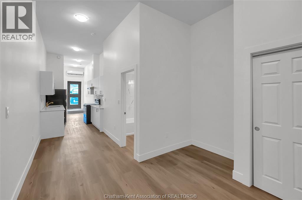 A long hallway with a door on the right.