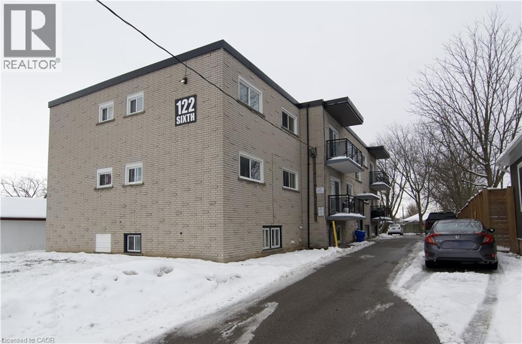 A building with the number 122 on it is surrounded by snow.
