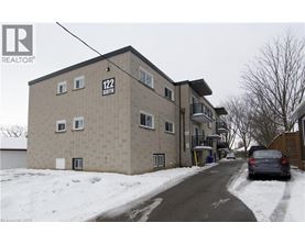 A building with the number 122 on it is surrounded by snow.