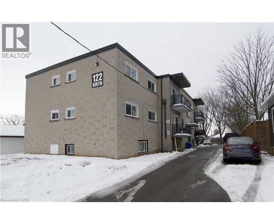 A building with the number 122 on it is surrounded by snow.