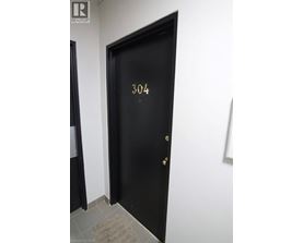 A black door with the number 304 on it.