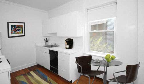 a small kitchen with a table and chairs and a window