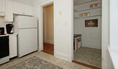 a kitchen with a white refrigerator and a stove
