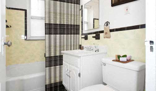 a bathroom with a toilet and a sink and a shower