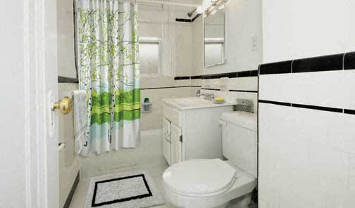 a white bathroom with a toilet and a sink