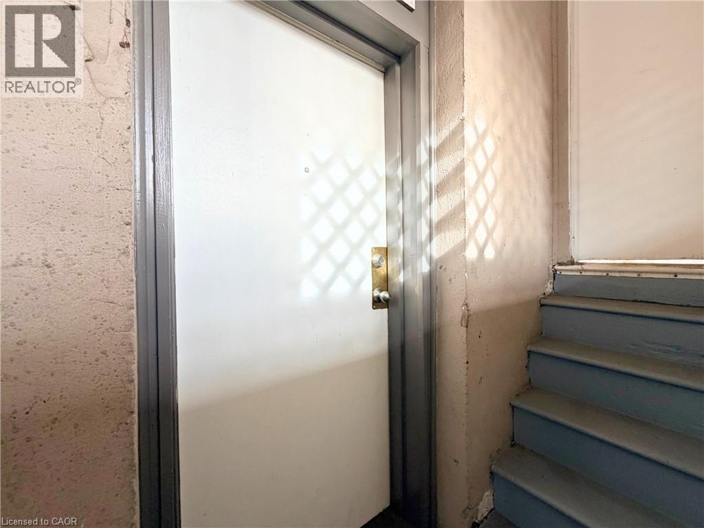 A door with a diamond pattern on the glass is open.