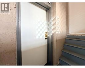 A door with a diamond pattern on the glass is open.