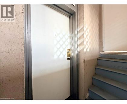 A door with a diamond pattern on the glass is open.