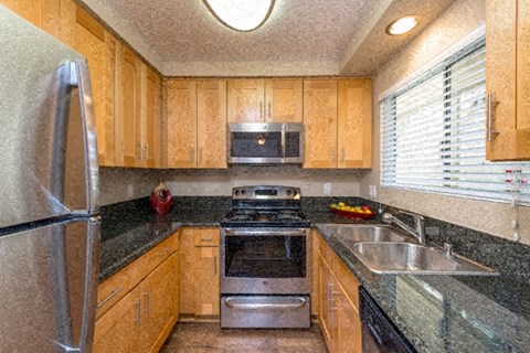 a kitchen with a stove sink and refrigerator