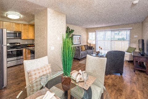 a living room and dining room with a glass table