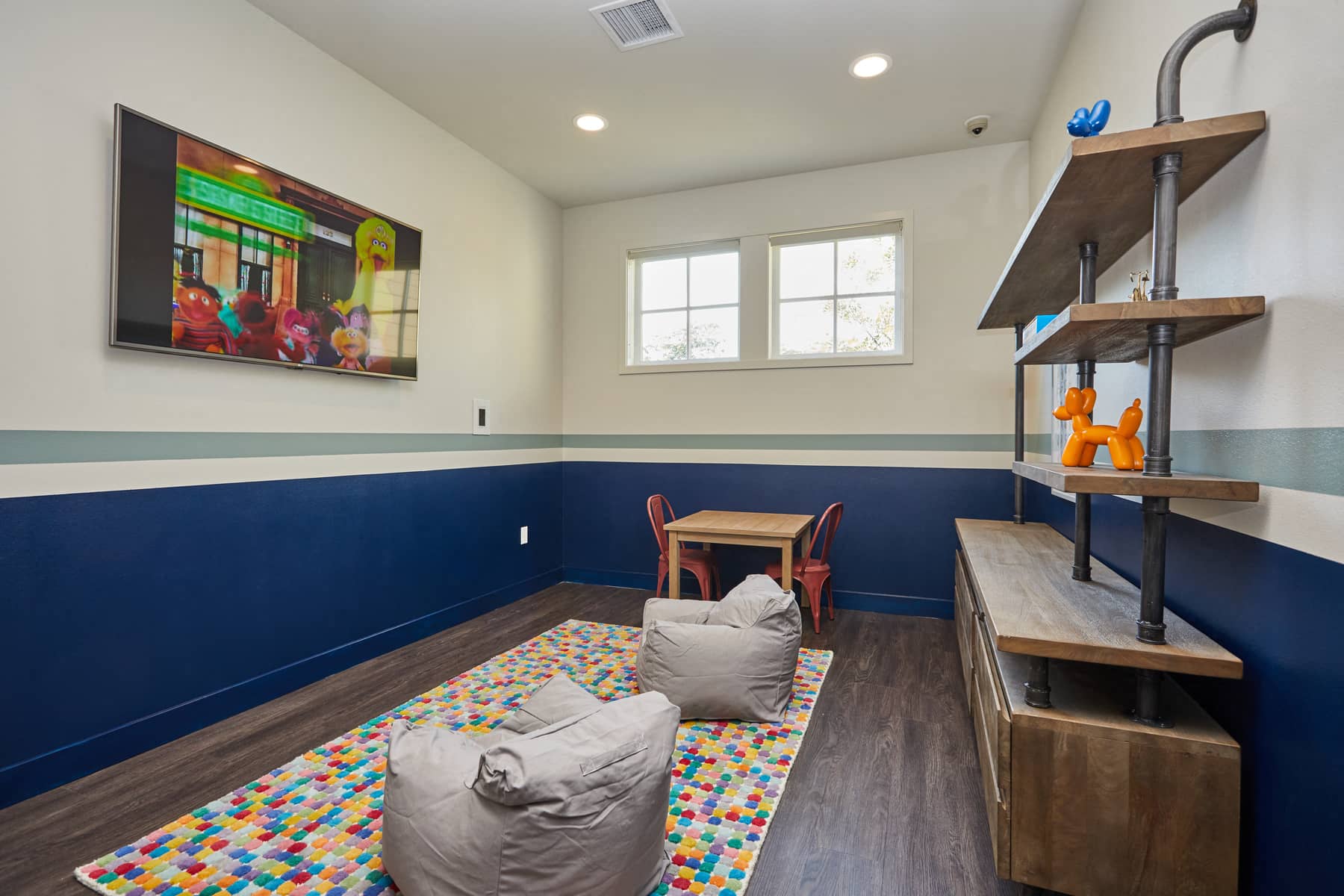 a playroom with a couch and a table and a tv