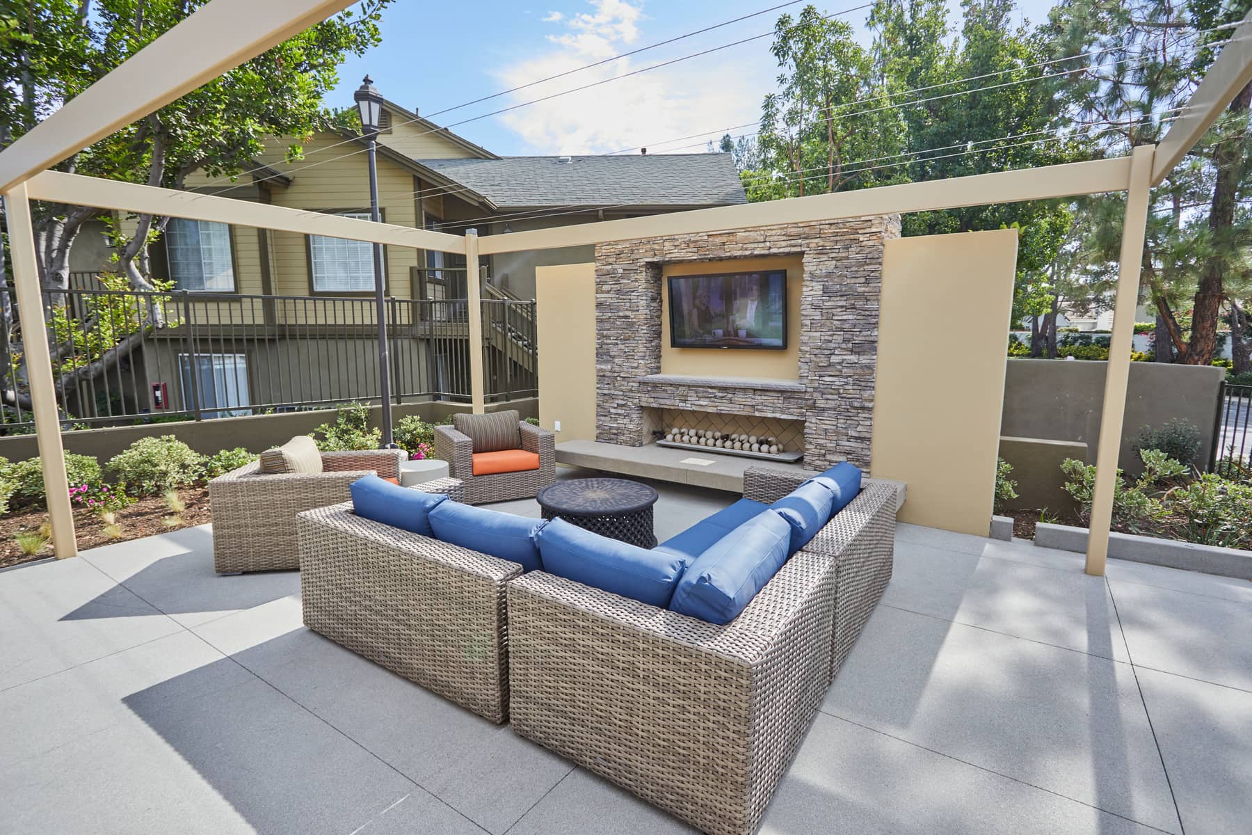 a patio with a couch and a fireplace