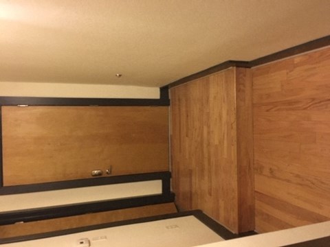 a bathroom with wooden walls and a bath tub
