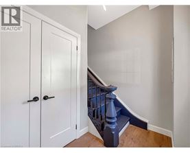A white door with a black handle is on the left side of the image.