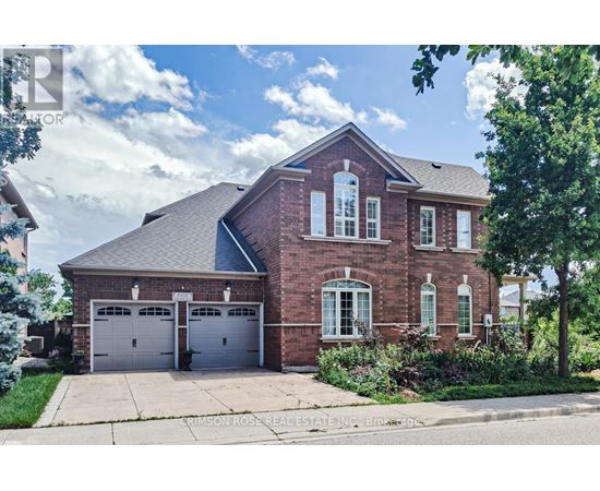 A brick house with a garage is for sale.