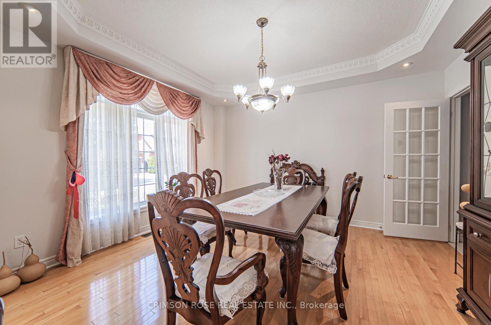A dining room with a wooden table and chairs.