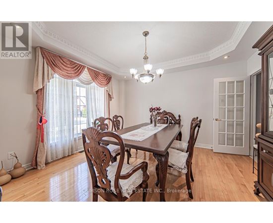 A dining room with a wooden table and chairs.