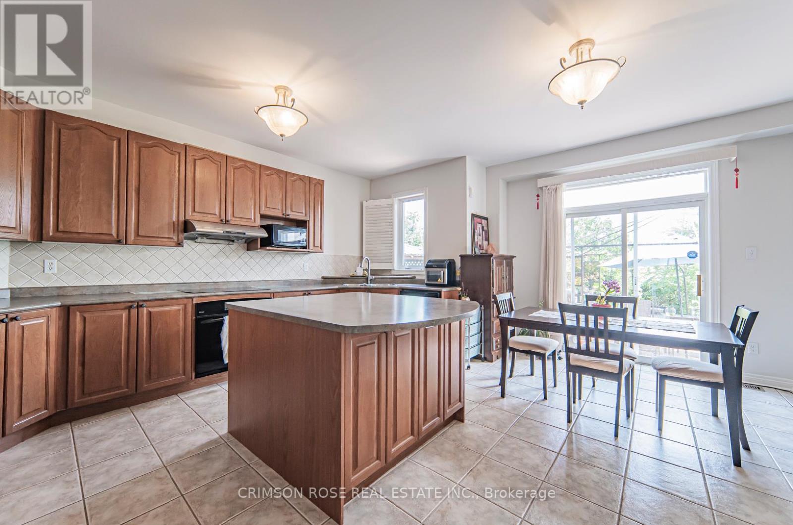 A kitchen with brown cabinets and a white countertop.
