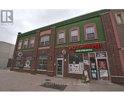 A brick building with a green roof and a sign that says Pizza Depot.
