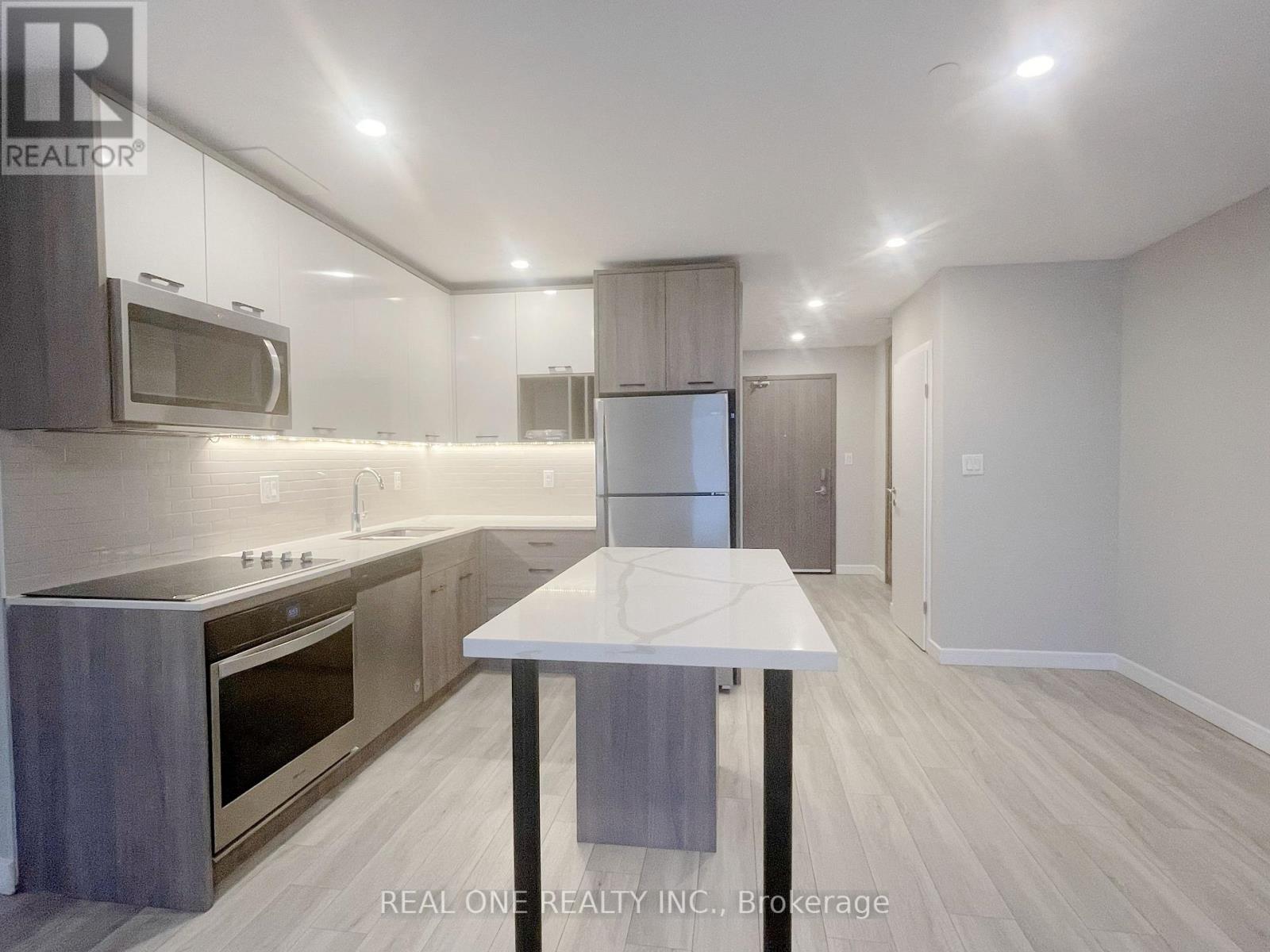 A modern kitchen with a table in the middle of the room.