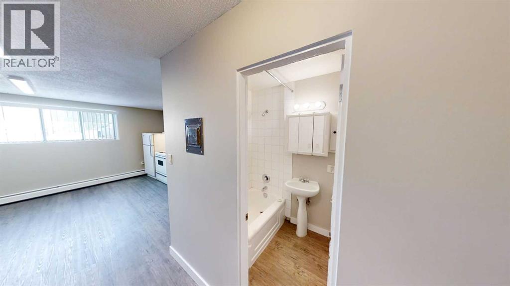 A bathroom with a toilet, sink, and bathtub is shown.