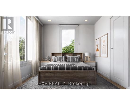 A bedroom with a large bed and a window with curtains.