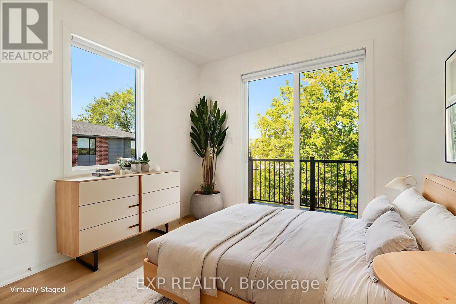 A bedroom with a bed, dresser, and sliding glass doors.