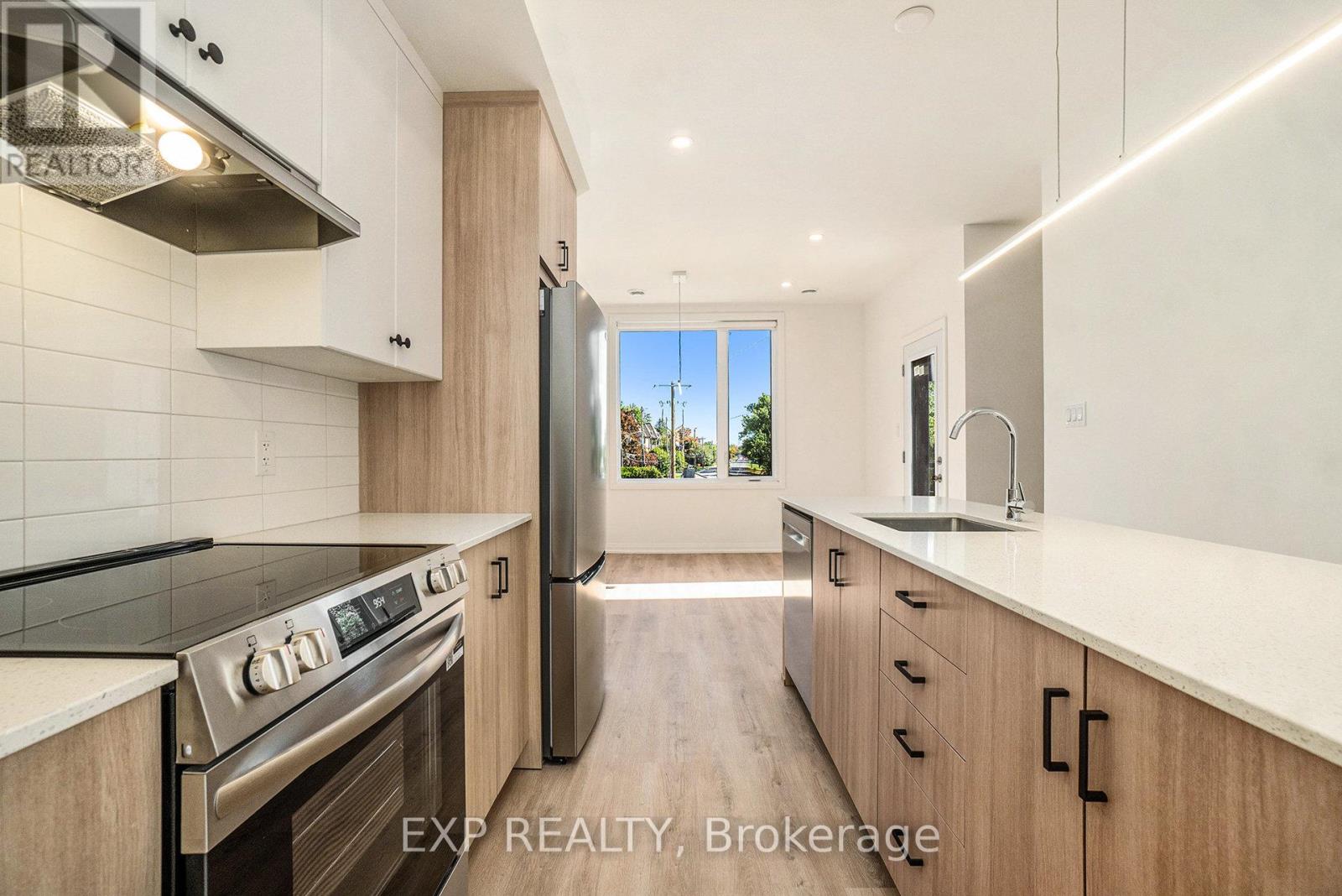 A modern kitchen with wooden cabinets and stainless steel appliances.