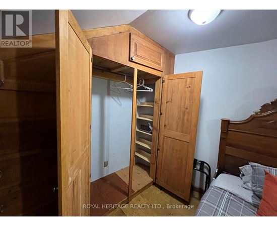 A bedroom with a bed, a wardrobe and a nightstand.