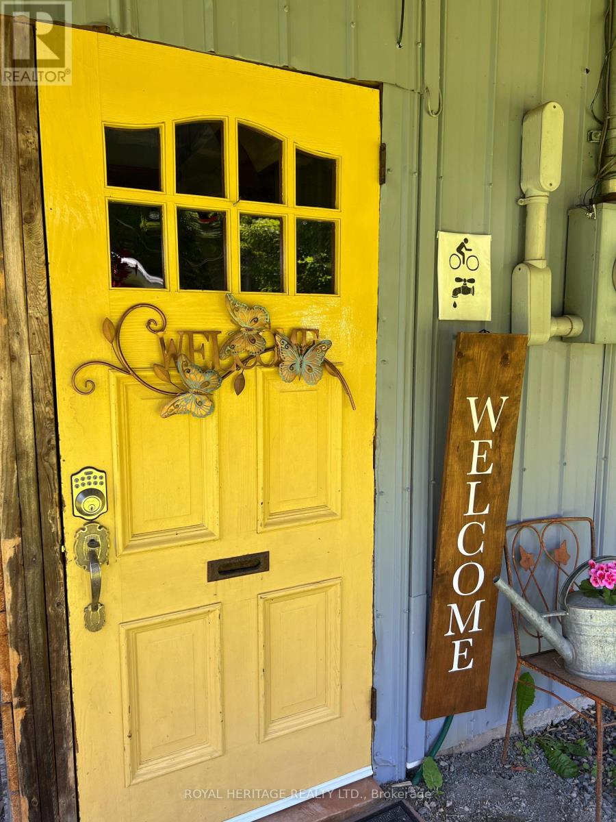A yellow door with a sign that says "welcome".