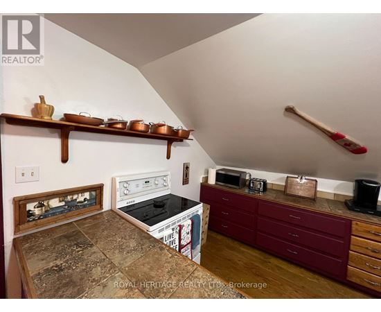 A kitchen with a stove top oven and a microwave on a counter.