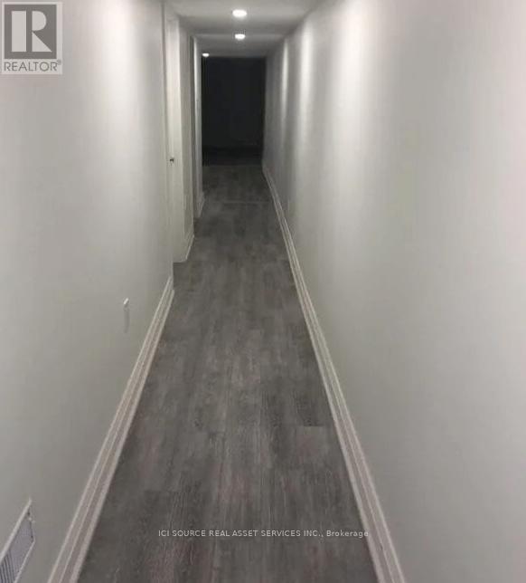 A long hallway with a light on the wall.